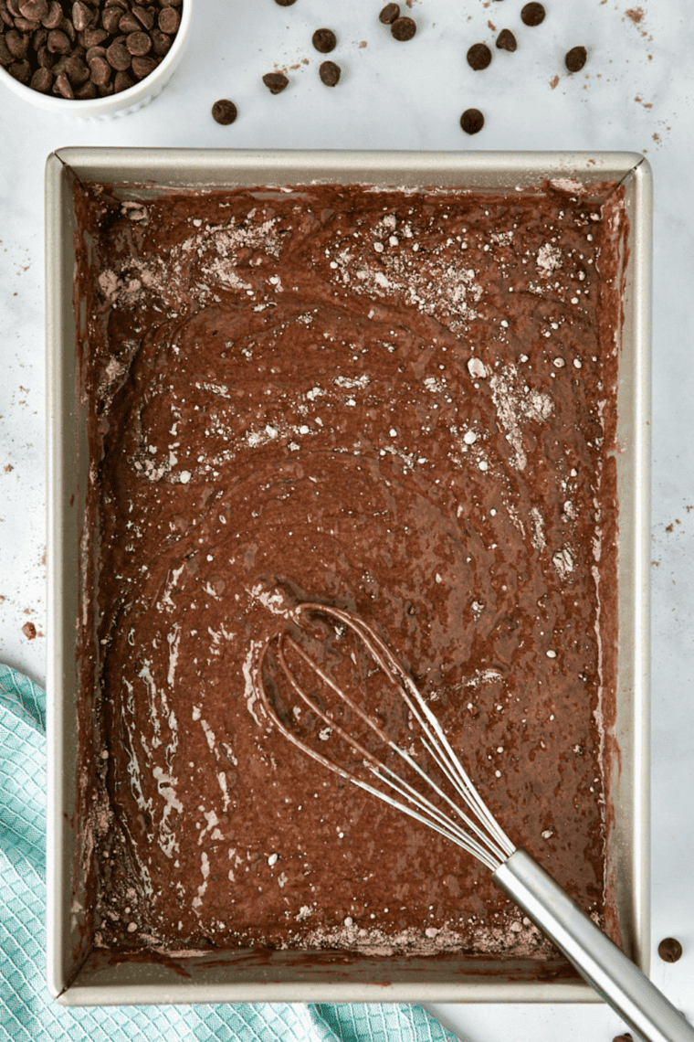 Coca-Cola cake batter in a 9x13 pan going into the oven to bake