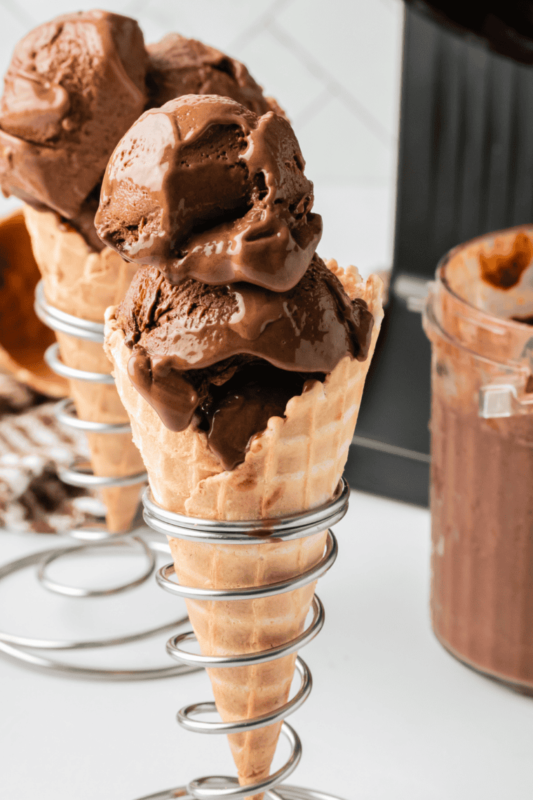 Ninja Creami World Class Chocolate ice cream scooped onto a waffle cone with a white chocolate mousse swirl