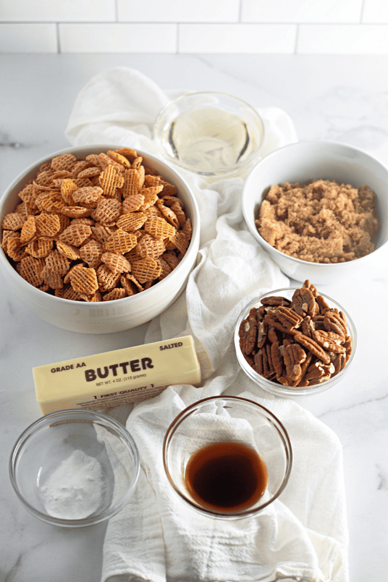 Ingredients for pecan praline Crispix snack mix: Crispix cereal, pecan halves, brown sugar, corn syrup, and butter