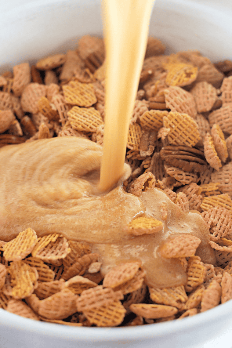 Coat the mix: Warm praline caramel poured over Crispix cereal and pecans and tossed to coat