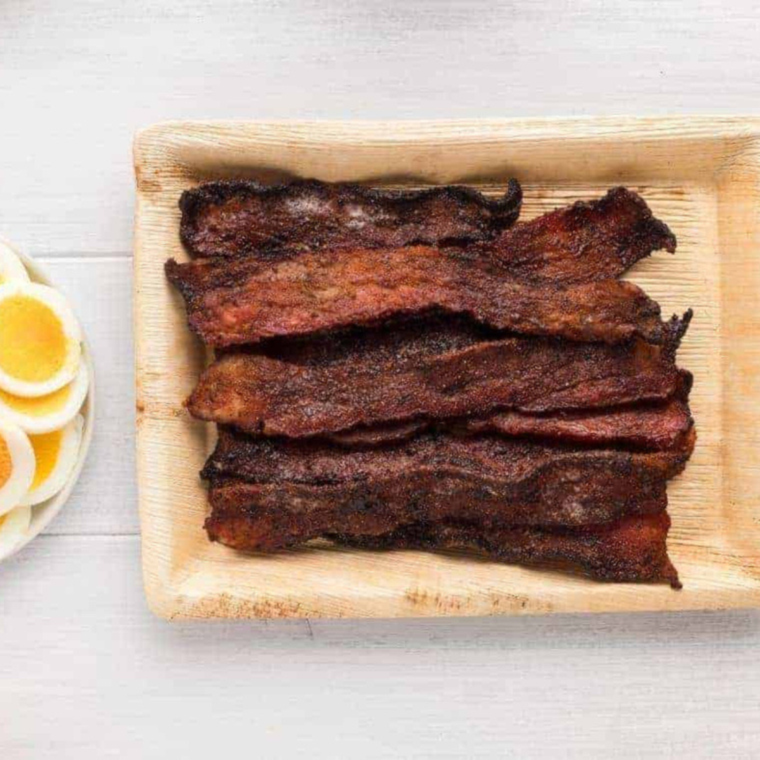 Close-up of crispy candied bacon showing the caramelized brown sugar glaze