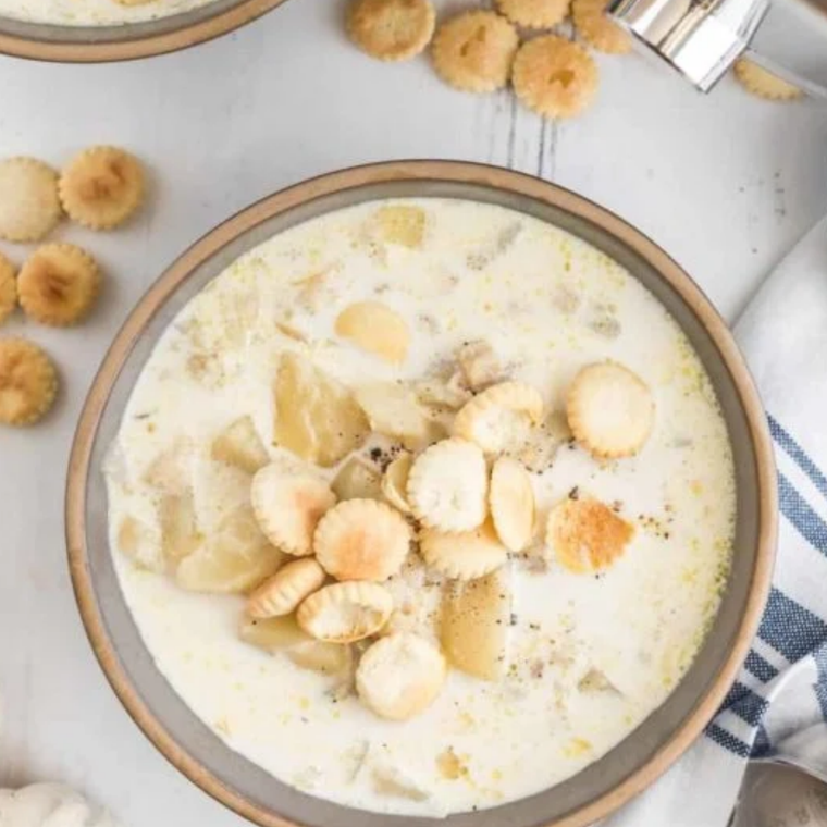 Bowl of creamy copycat Culver’s clam chowder topped with bacon, parsley, and oyster crackers