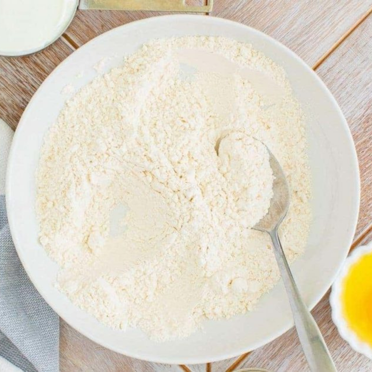 Hardee's-style biscuit dough mixed with self-rising flour, buttermilk, oil, and yeast in a bowl