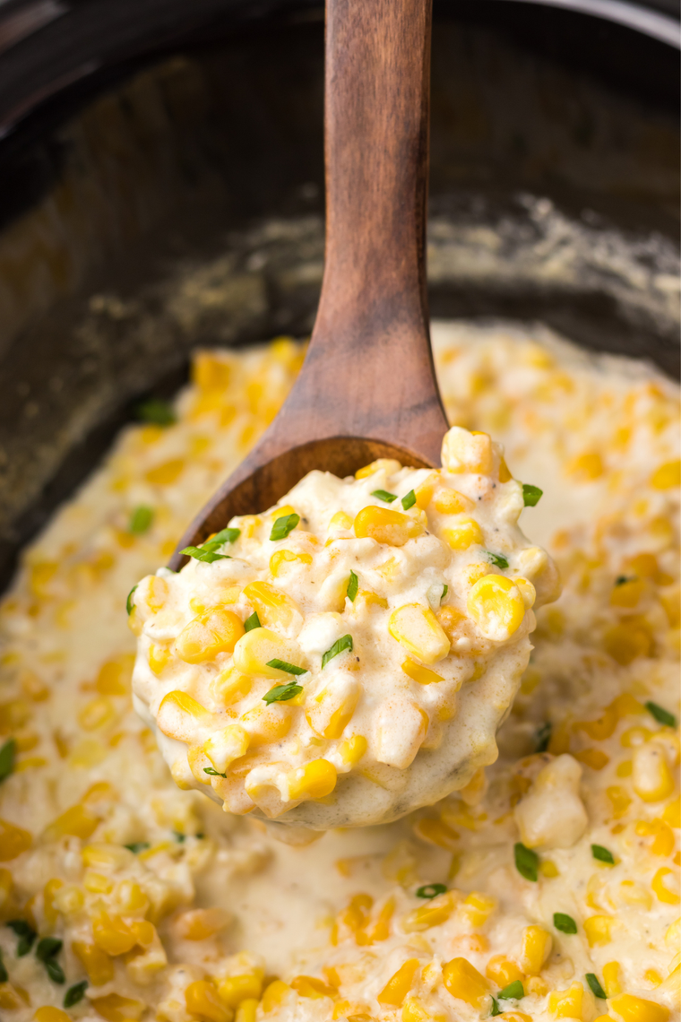 Stirring a flour and milk slurry into slow cooker creamed corn to thicken the sauce.