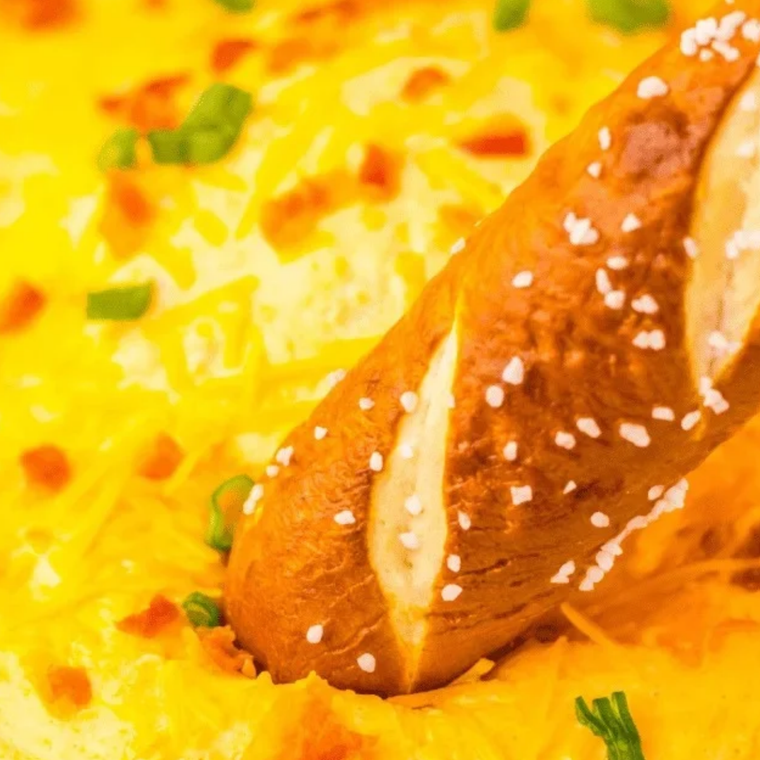 Bowl of warm Culver’s-style cheddar cheese sauce ready for dipping